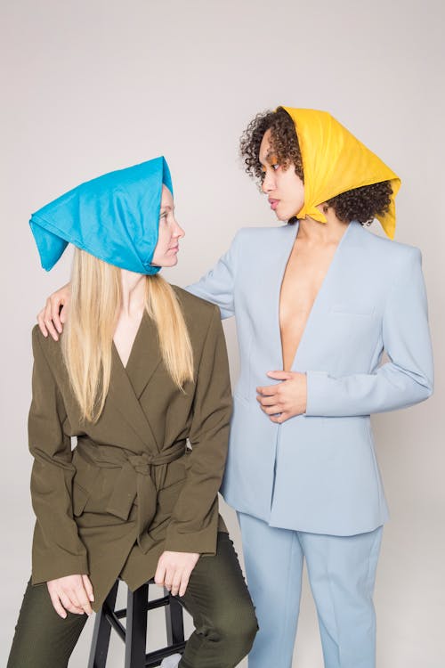 Free Stylish friends in colorful clothes looking at each other Stock Photo