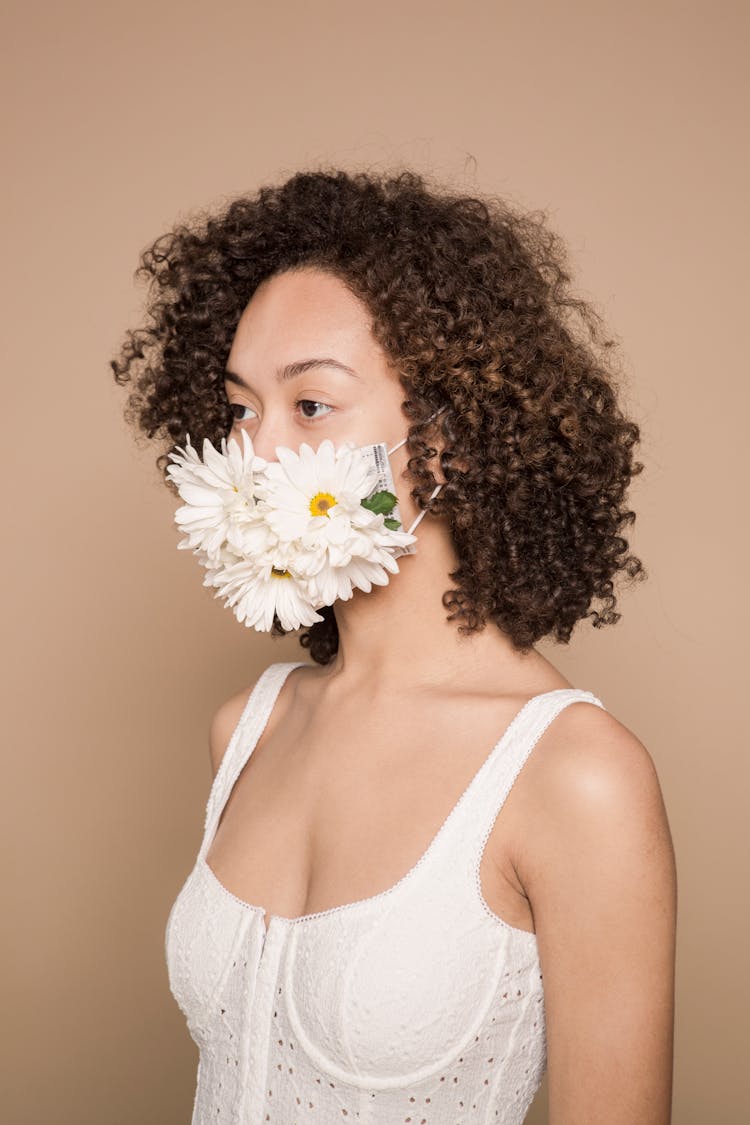 Slender Gentle Ethnic Woman In Mask Decorated With White Flowers