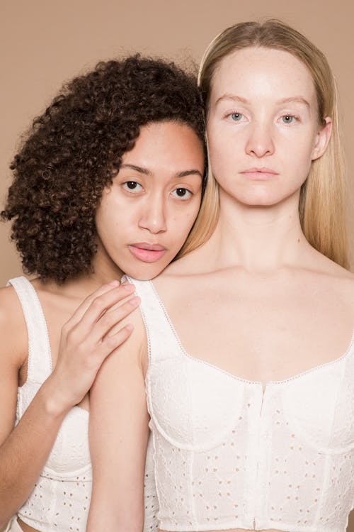 Multiethnic women in white lingerie in studio