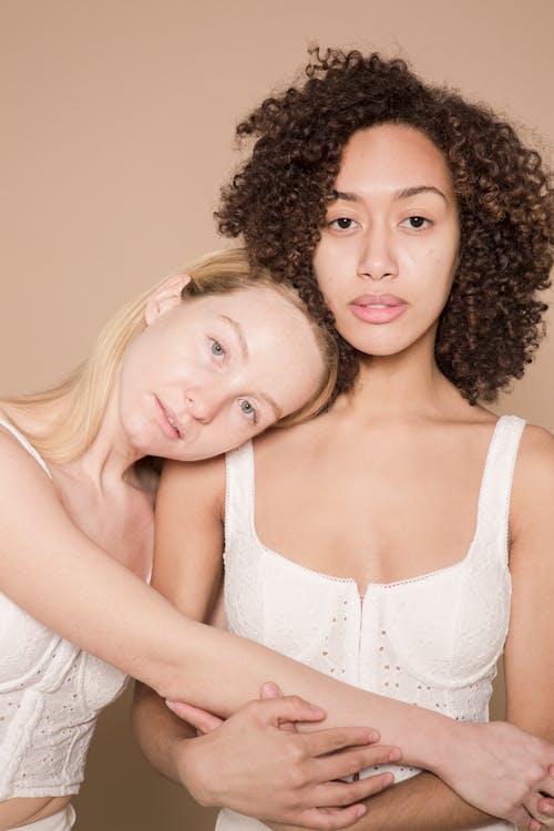 Free Gentle diverse women in white lingerie bonding Stock Photo