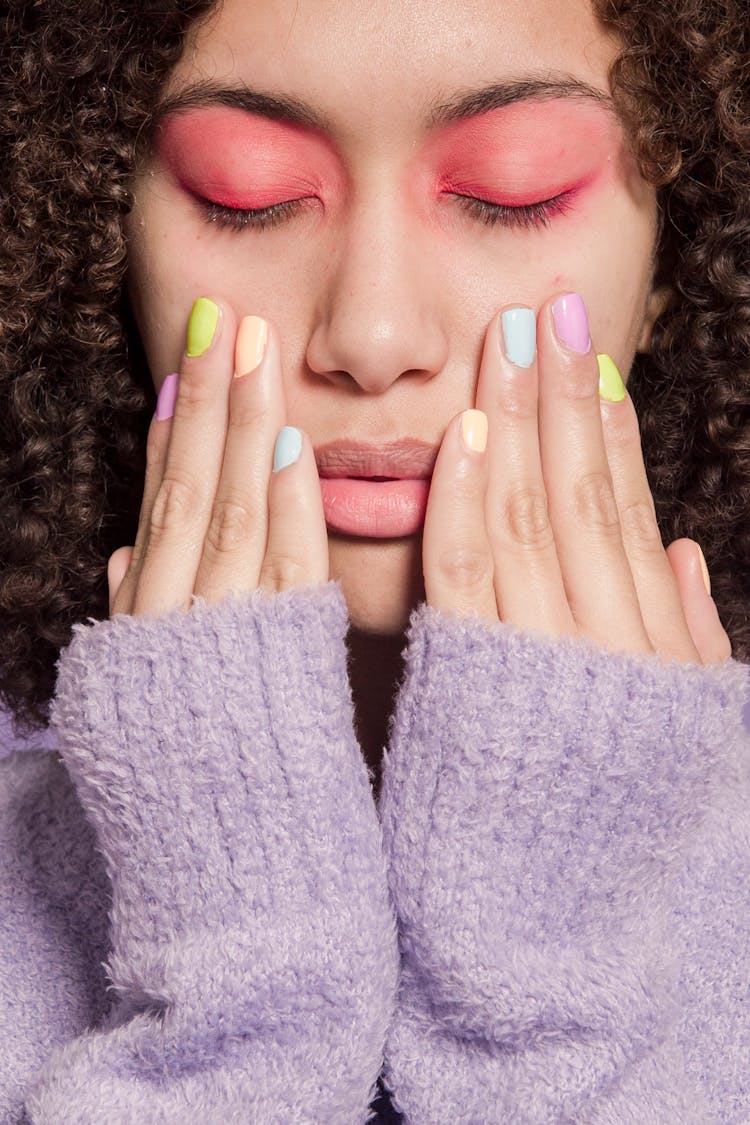 Thoughtful Ethnic Woman Touching Face With Hands With Pastel Nails