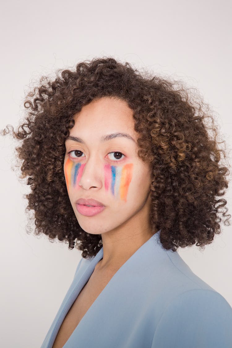 Serious Ethnic Lady With Colorful Rainbow Makeup In Studio