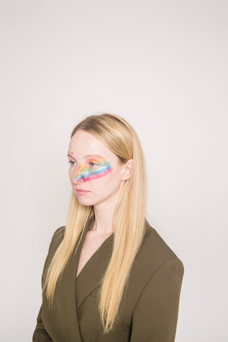 Serious Woman With Colorful Rainbow Makeup In Studio