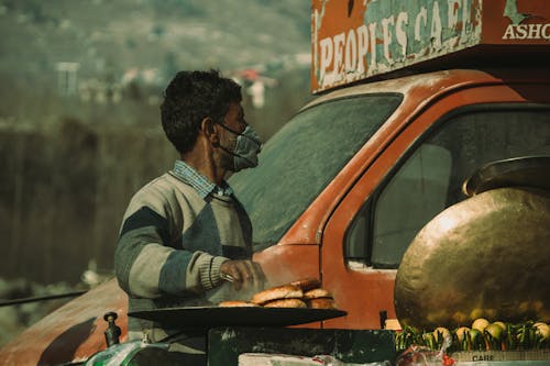 Man Cooking While Wearing Face Mask