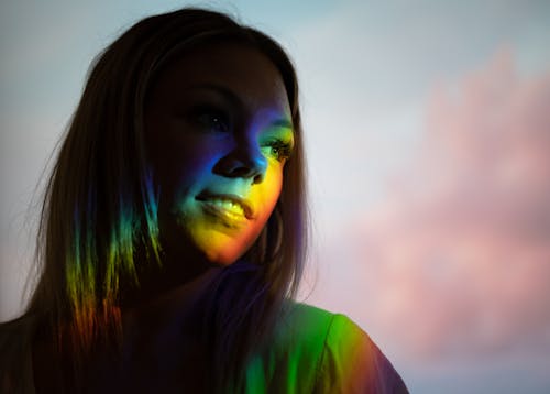 Young woman with neon light on face