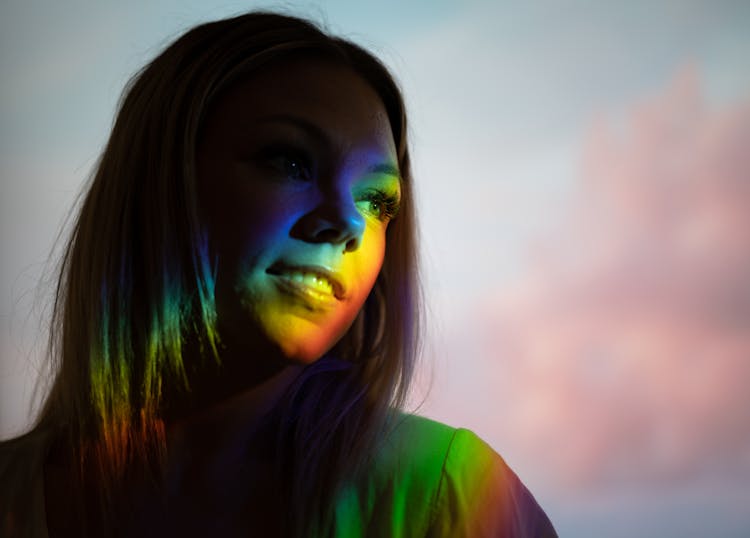 Young Woman With Neon Light On Face