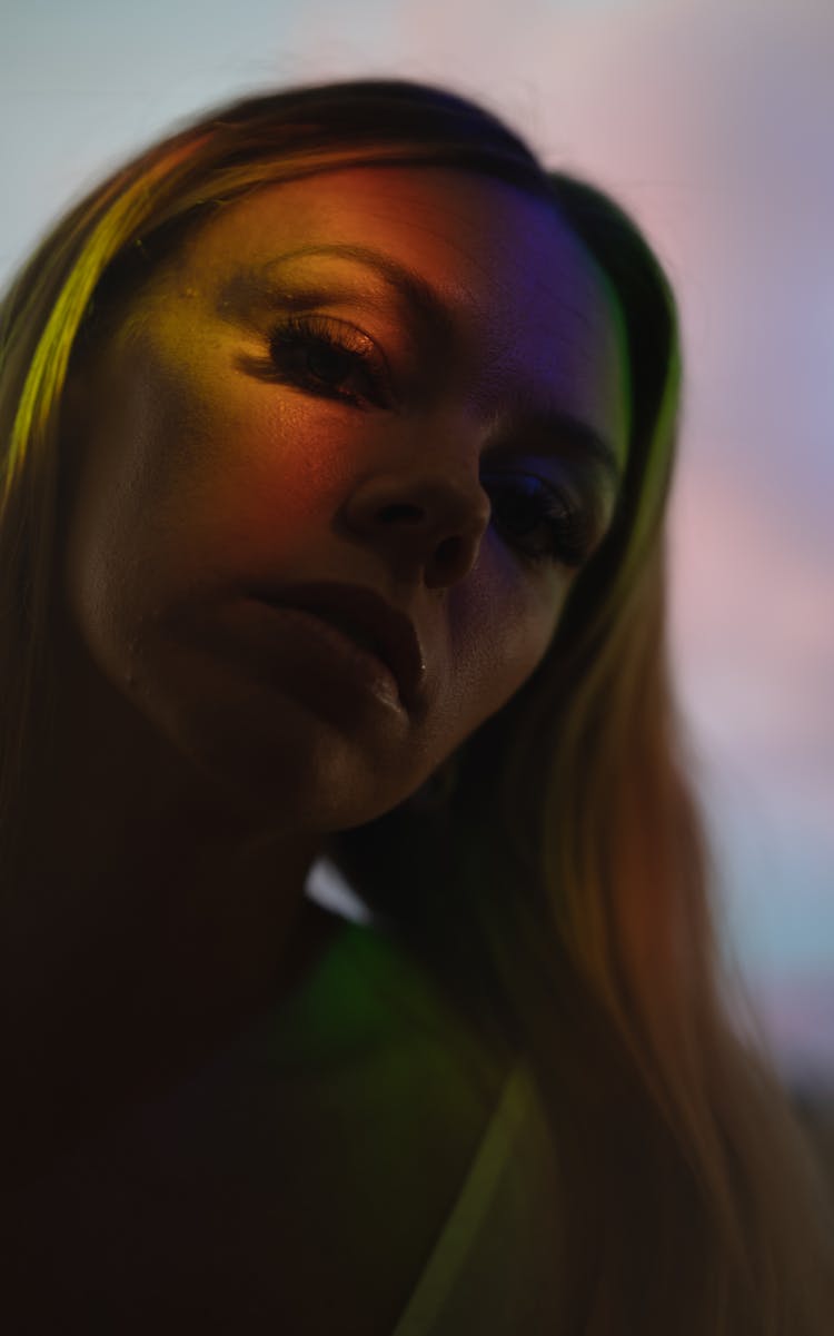 Sensual Woman With Makeup And Colorful Light On Eye