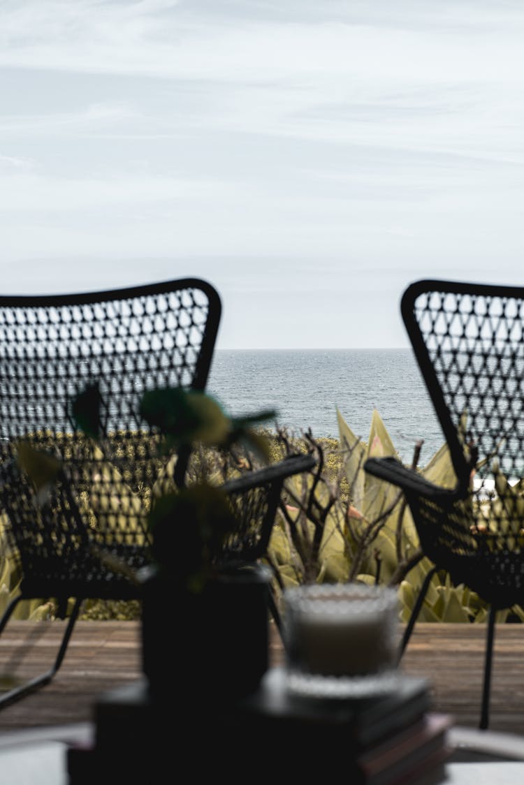 Terrace With Chairs On Wooden Floor Overlooking Ocean