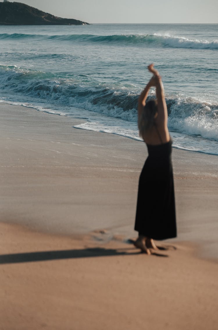 Unrecognizable Woman Standing On Sandy Beach