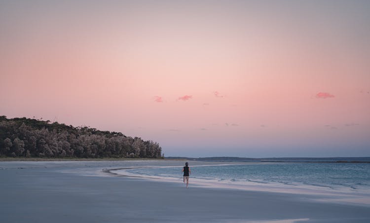 Man Running On Beach At Dawn