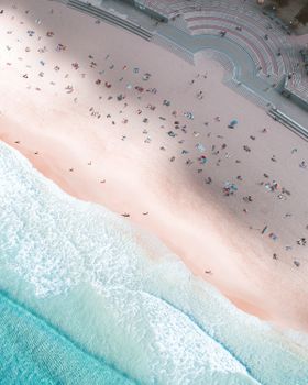 A mesmerizing aerial shot of Coogee Beach, NSW, showcasing the vibrant shoreline and beachgoers enjoying a sunny day.