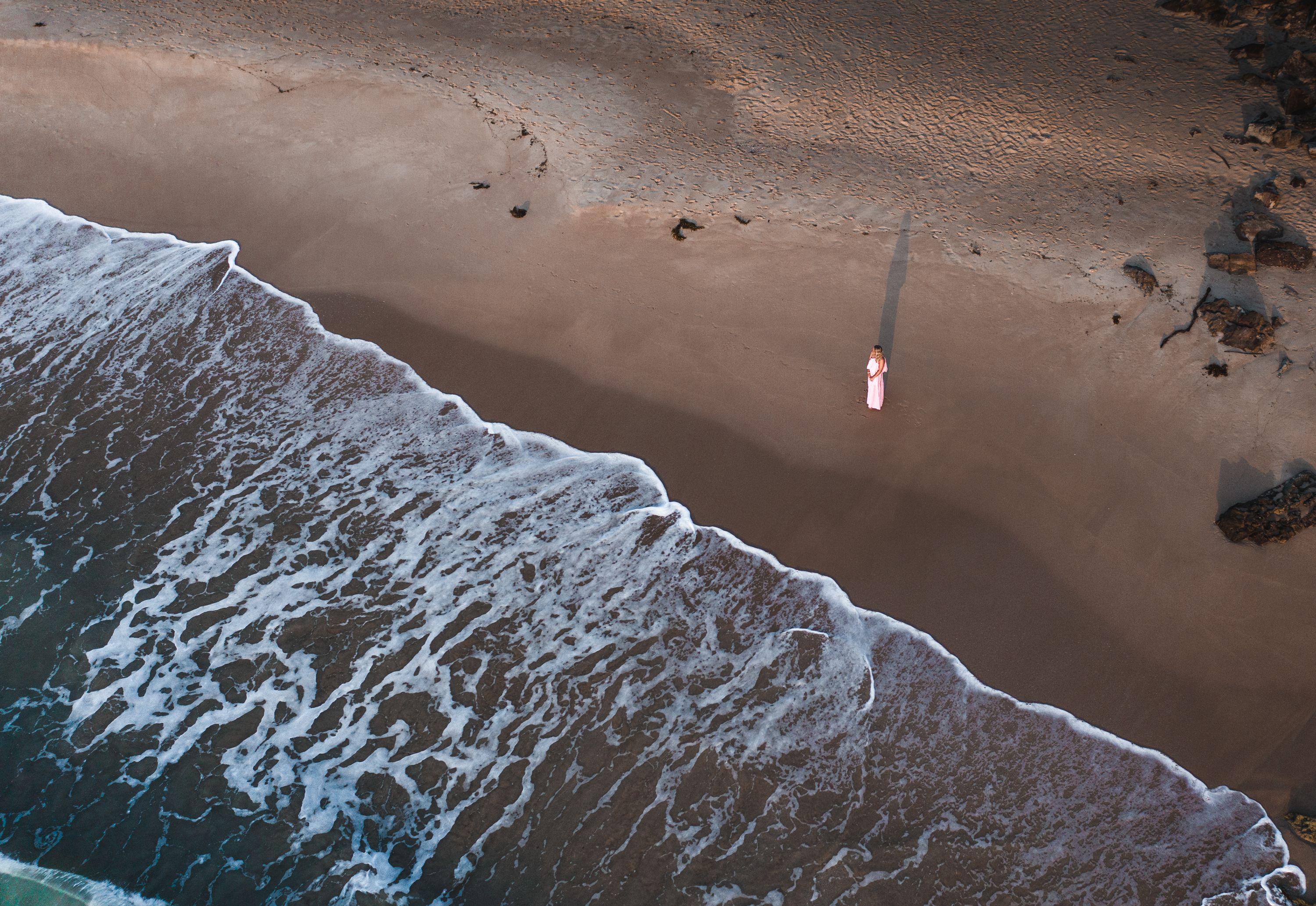 A Woman in Pink Dress Standing on the Shore · Free Stock Photo