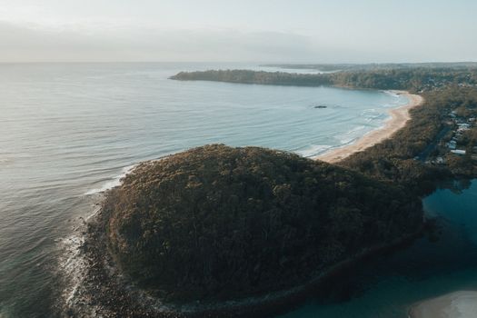 Drone shot over Lake Conjola's scenic coastline in NSW, Australia, capturing stunning natural beauty.