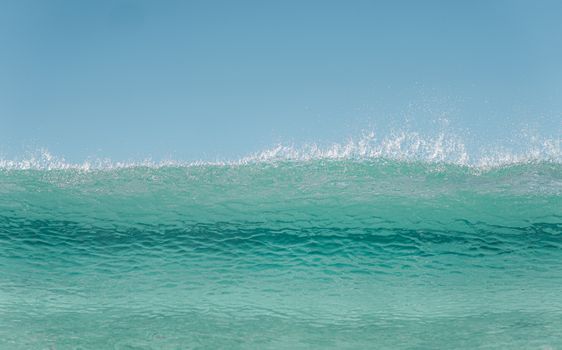 Picturesque seascape of turquoise wavy ocean against cloudless blue sky in sunny day