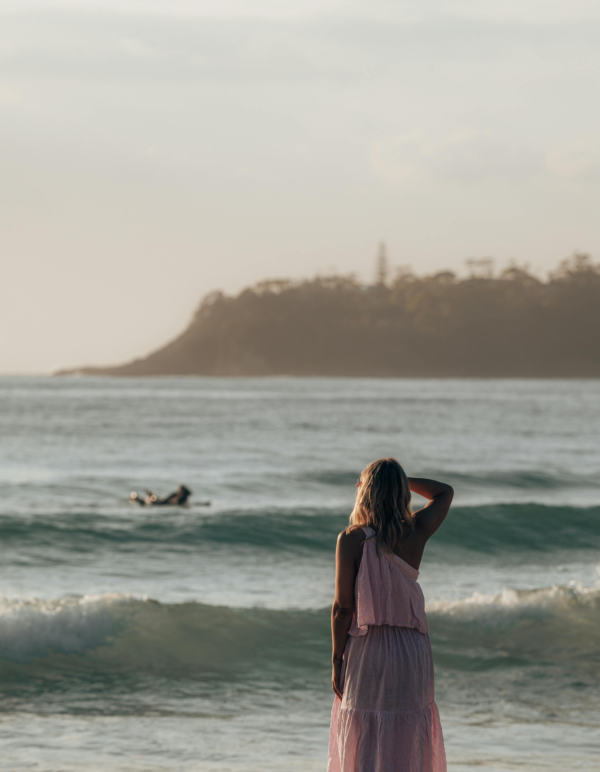 unrecognizable female admiring waving ocean view on coast