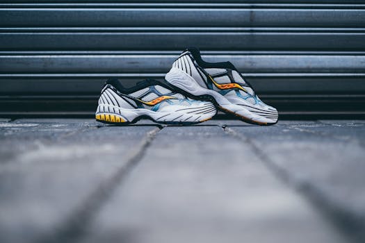 Close-up of modern athletic sneakers with vibrant details on a concrete surface.