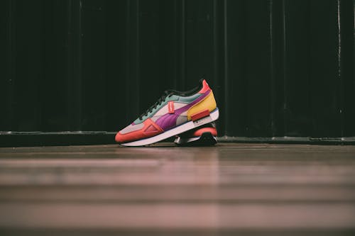 Free A Colorful Sneakers on a Wooden Floor Stock Photo