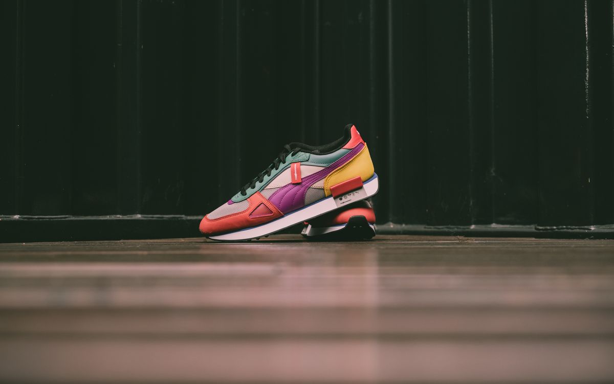 Vibrant sneaker in bold colors on a wooden floor background.
