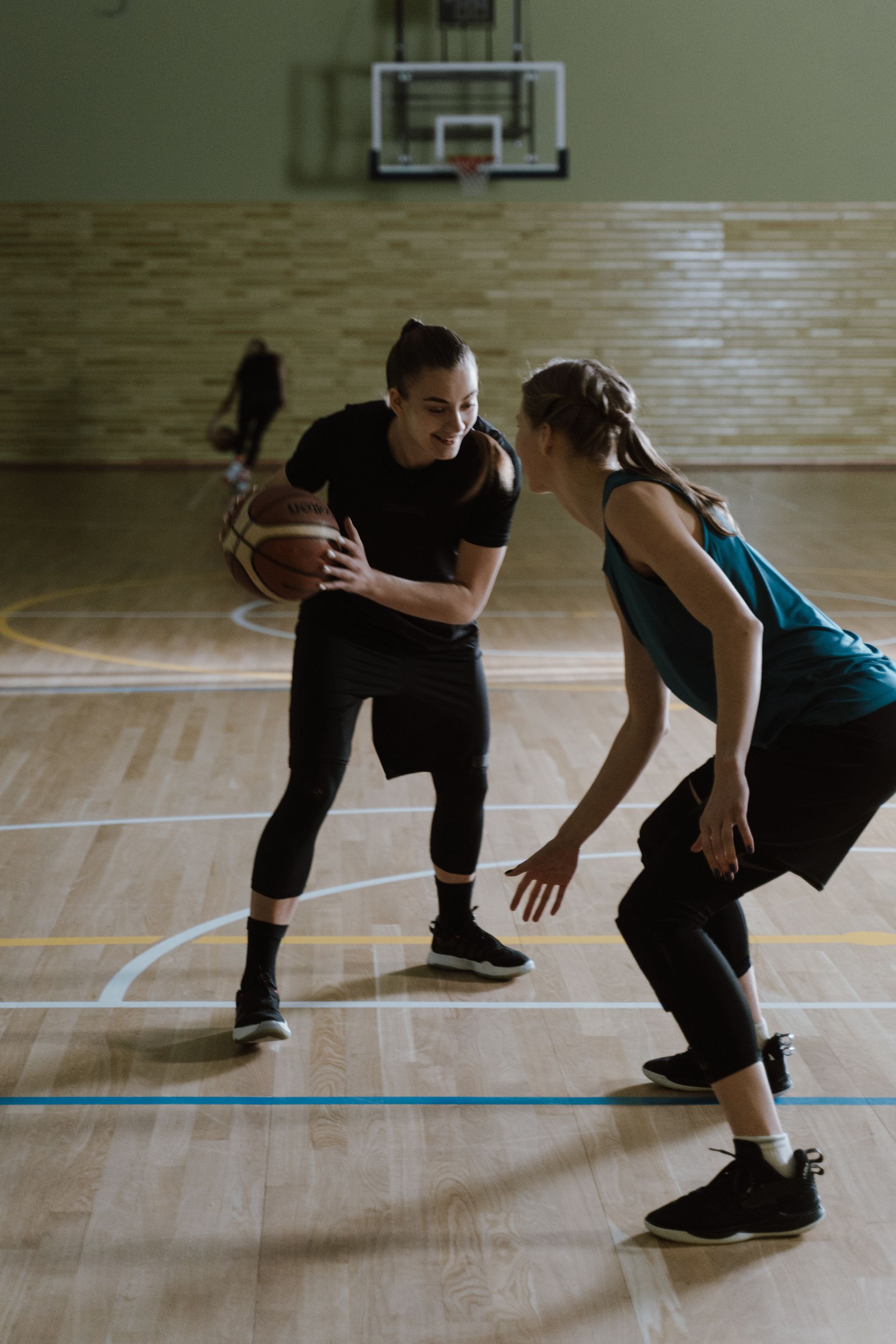 Two players facing off in a dark gym
