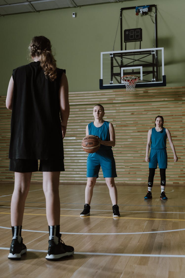 A Group Of Woman Playing Basketball 