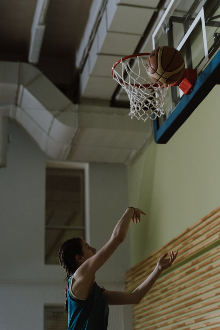 Woman In Blue Jersey Playing Basketball