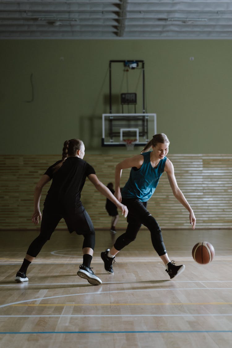 A Woman Running After A Basketball