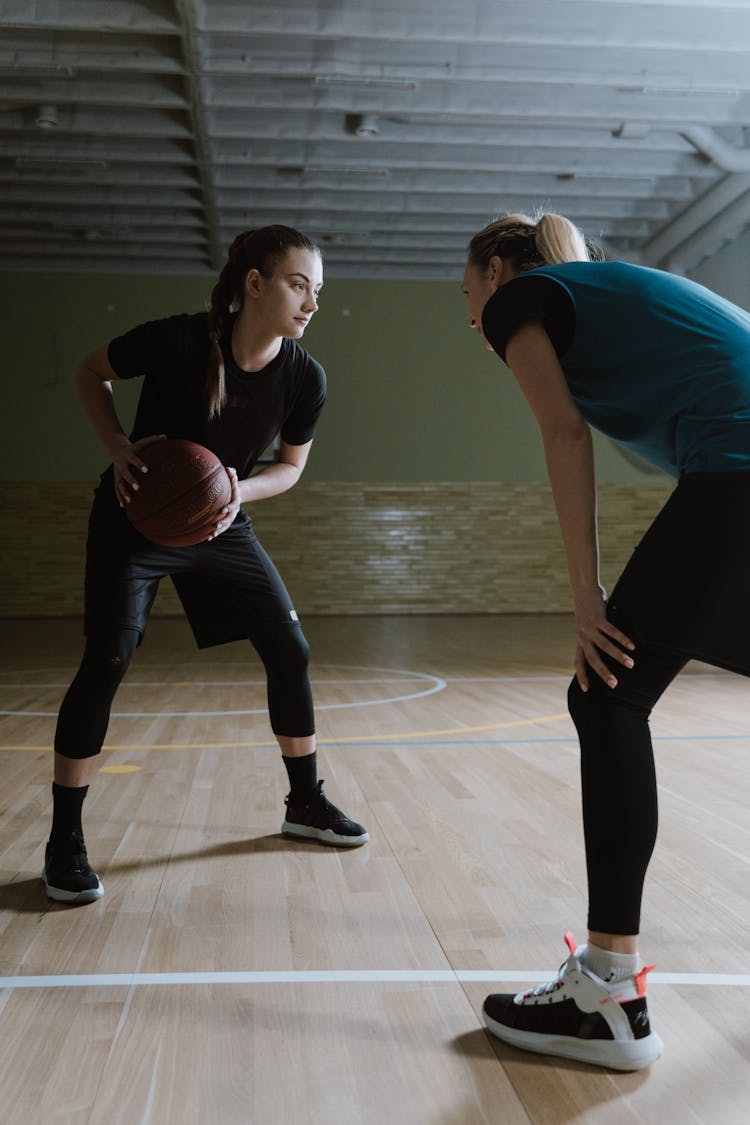 Women Playing A Game Of Basketball