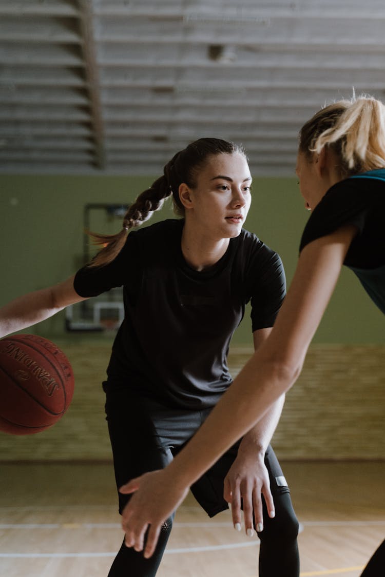 Woman In Black Shirt Holding Basketball Ball