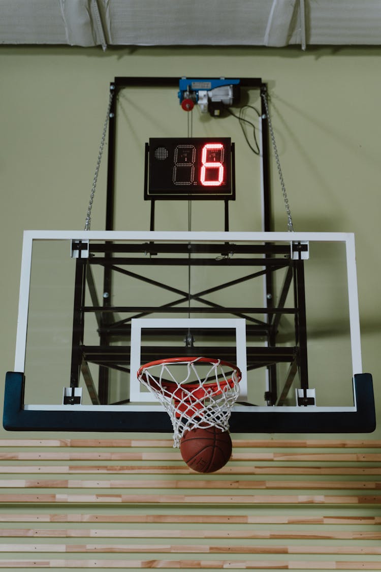 Brown Ball On Basketball Hoop