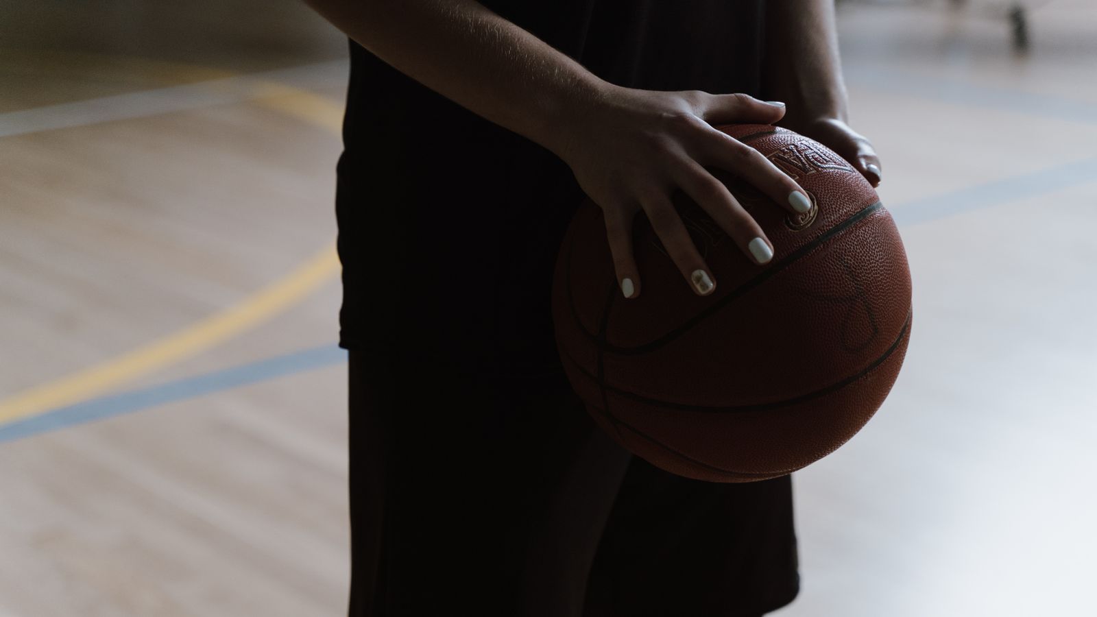 Representative licensed photograph of a basketball player holding a ball indoors; not Victor Wembanyama, the Spurs, Kings or their October 27 game