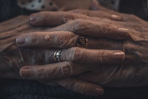 Free Intimate close-up of elderly hands adorned with rings, showcasing wrinkles and age. Stock Photo