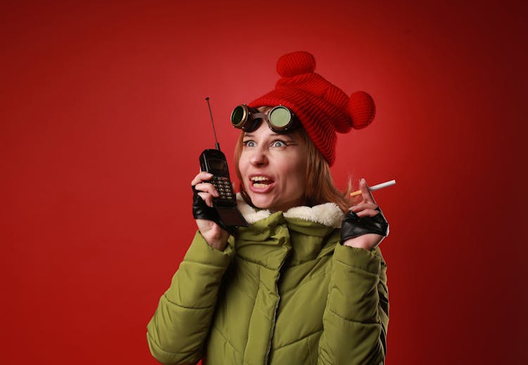 Excited Woman With Vintage Goggles Speaking Into Walkie Talkie