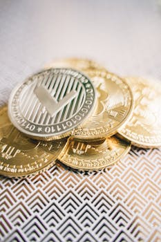 Detailed view of gold and silver cryptocurrency coins on a geometric patterned surface.