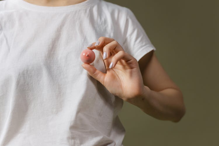 Close Up Of Woman Holding Breast Toy