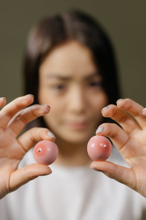 Woman Hands Holding Breasts Dolls