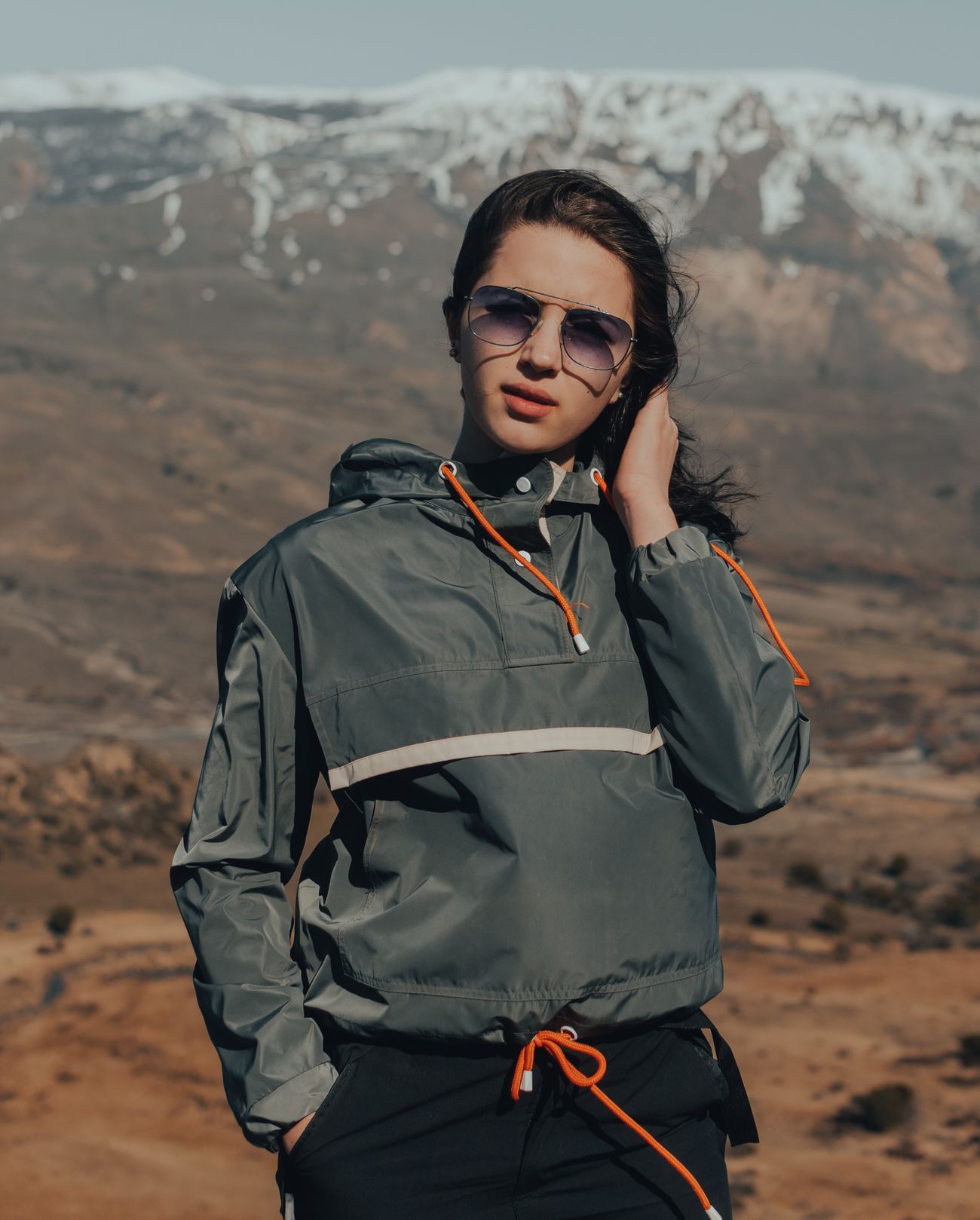 Model wearing the Crosswind Ripstop Anorak on an exposed ridge — photo by Gaspar Zaldo on Pexels