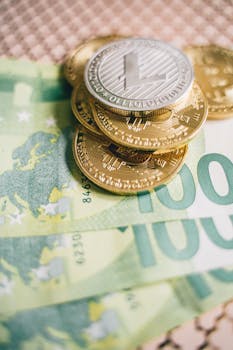 Stack of cryptocurrency coins on Euro banknotes symbolizing finance and digital currency concepts.