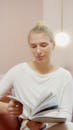 Woman in White Shirt Holding a Book
