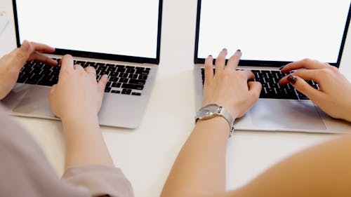 Free Hands of Persons on a Laptop Keyboard  Stock Photo