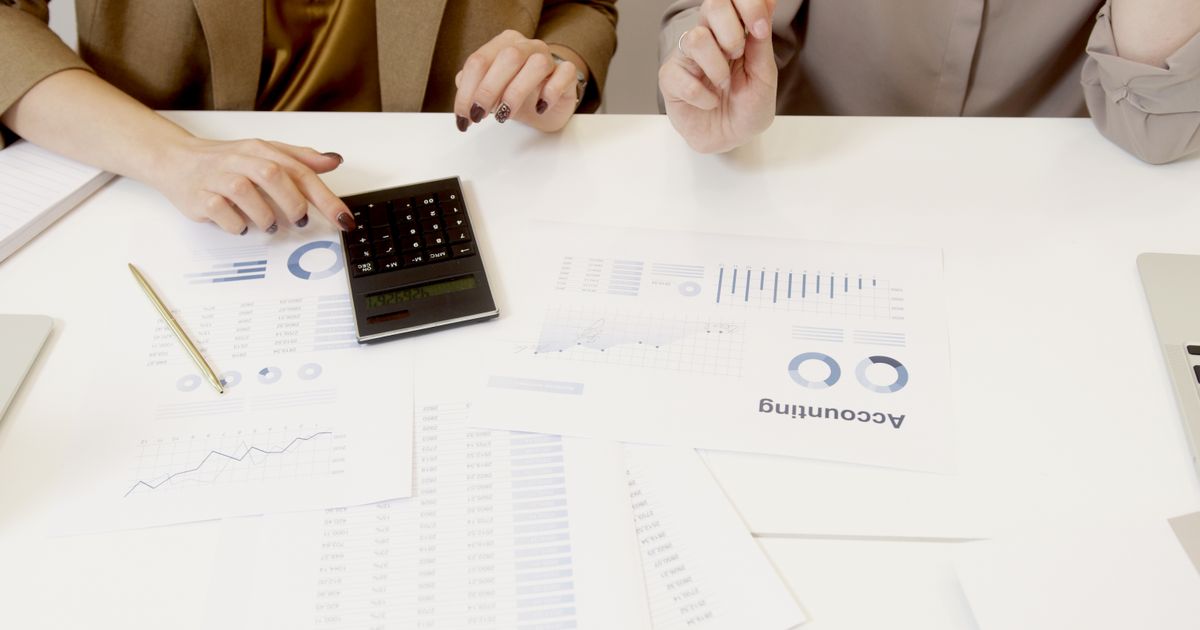 Financial advisor discussing budgeting strategies with a person at a desk.
