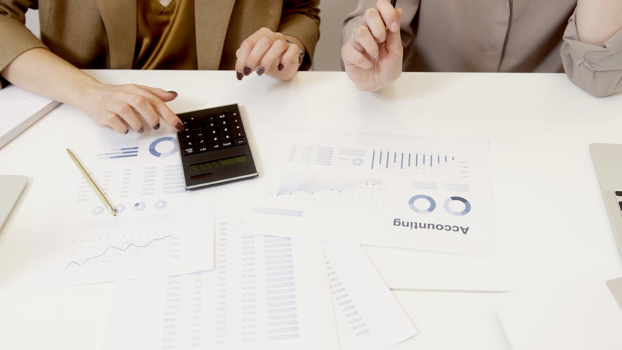 Free Two Women Working with Accounting Data  on Table Stock Photo