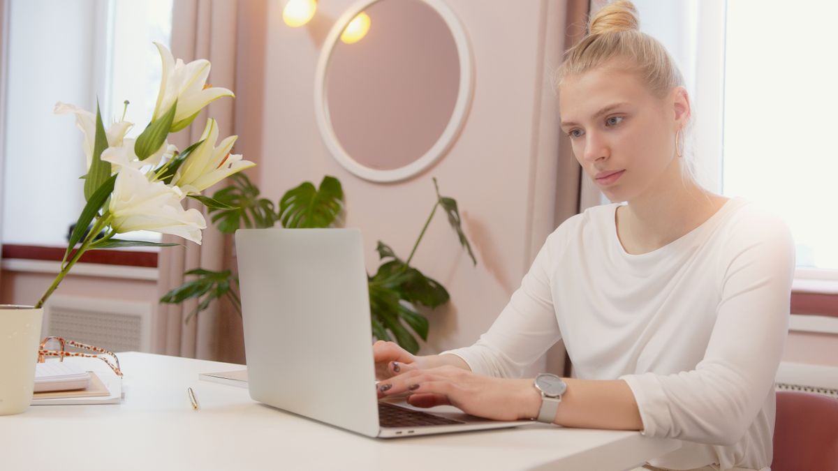 Technology professional on a call at a laptop