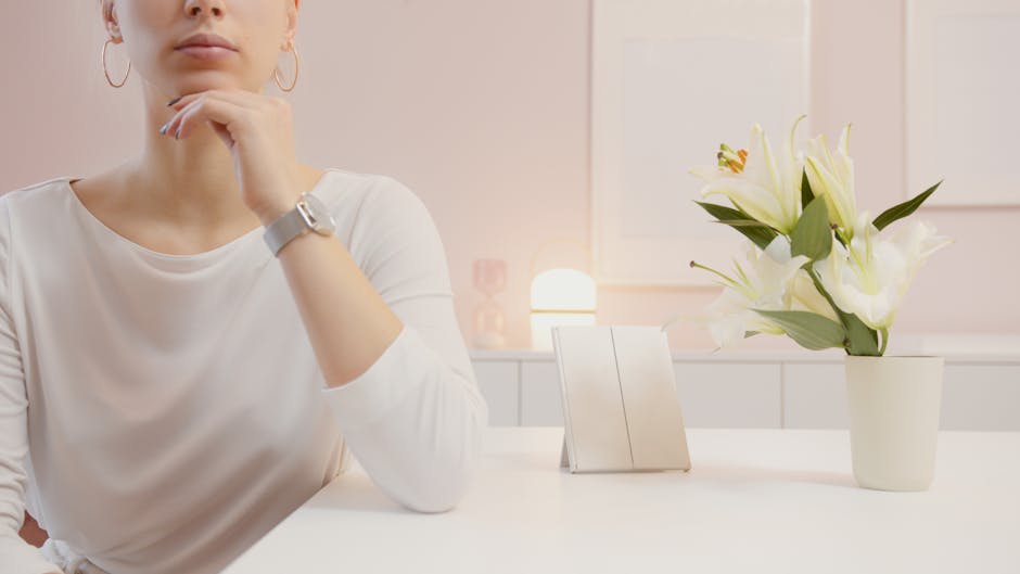 A stylish woman in a serene, minimalistic room with white lilies.