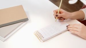 Hands writing in a notebook, photo by Artem Podrez on Pexels