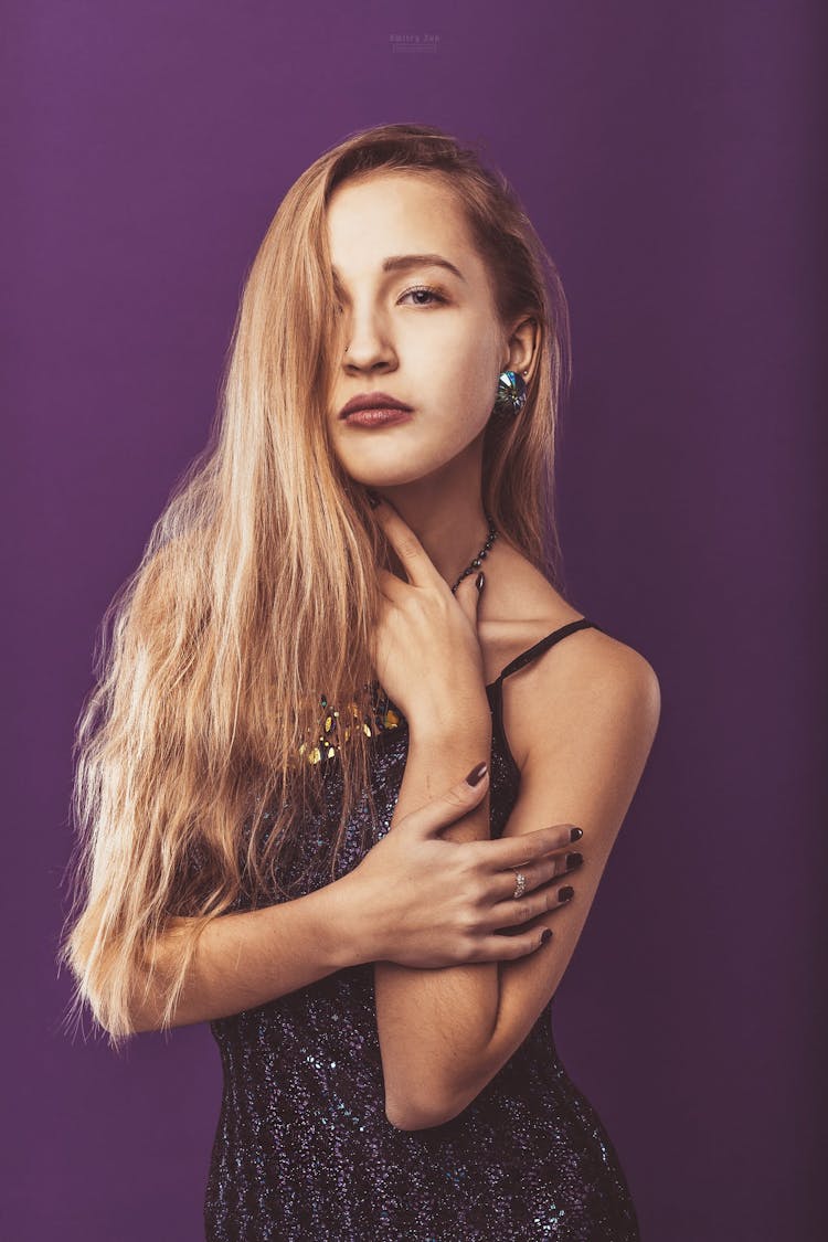 Alluring Woman With Long Hair Standing In Studio