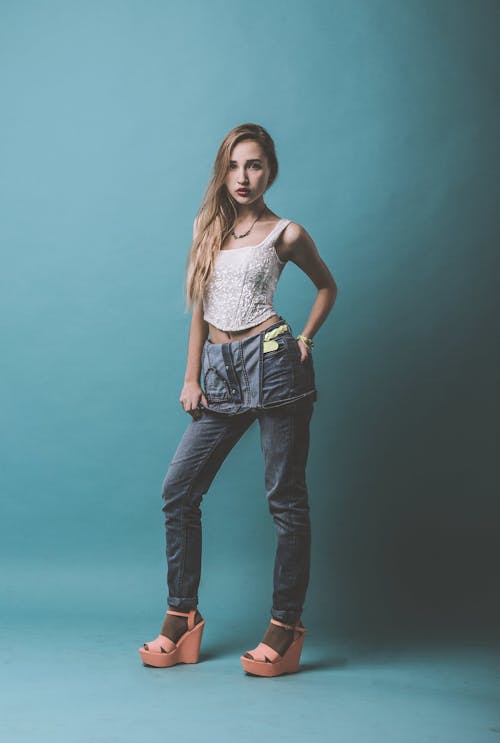 Confident woman wearing denim outfit standing in studio