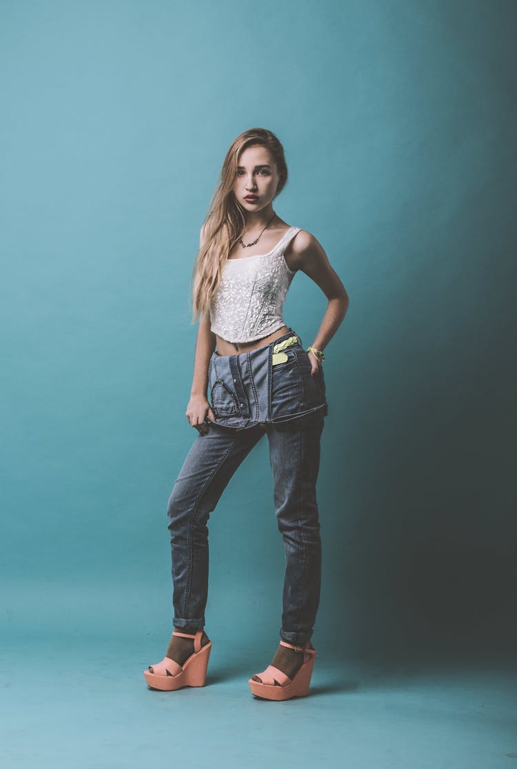 Confident Woman Wearing Denim Outfit Standing In Studio