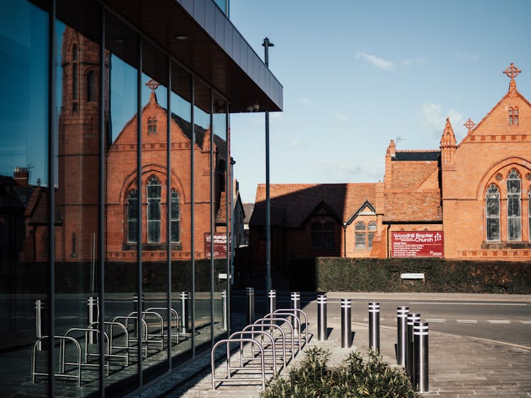 Woodhill Baptist Church Reflecting In A Glass Building 