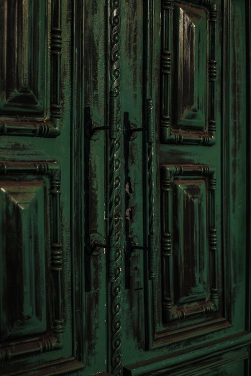 Vintage weathered door with ornamental elements and handles