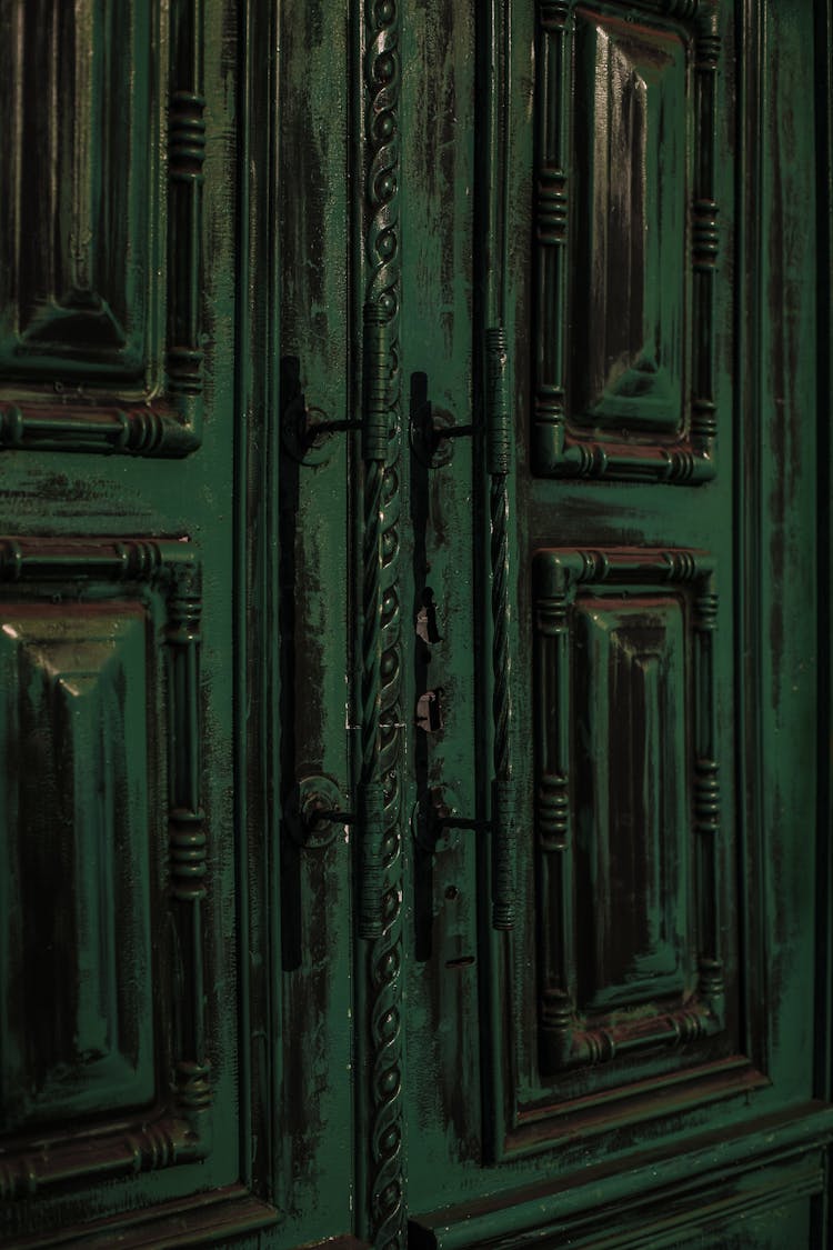 Vintage Weathered Door With Ornamental Elements And Handles